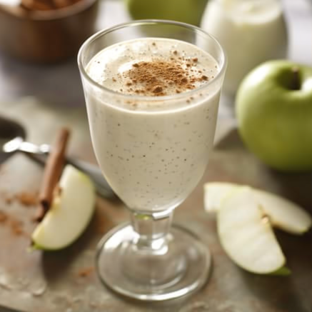 A creamy Cherry Cheer smoothie bursting with goodness, elegantly topped with a sprinkle of cinnamon. Surrounding it, fresh sliced green apples, a whole crisp green apple, and aromatic cinnamon sticks rest on a rustic wooden surface. A cheerful cherry garnish adds a vibrant pop of color to this refreshing and health-boosting treat. In the backdrop, another glass of our energizing Cherry Cheer awaits—just one of the many eco-friendly delights from Zestful Blends! A creamy Cherry Cheer smoothie bursting with goodness, elegantly topped with a sprinkle of cinnamon. Surrounding it, fresh sliced green apples, a whole crisp green apple, and aromatic cinnamon sticks rest on a rustic wooden surface. A cheerful cherry garnish adds a vibrant pop of color to this refreshing and health-boosting treat. In the backdrop, another glass of our energizing Cherry Cheer awaits—just one of the many eco-friendly delights from Zestful Blends!