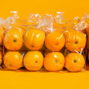 Experience a burst of goodness with our vibrant Orange Pack from Zestful Blends! This neatly stacked assortment of bright, juicy oranges is beautifully wrapped in eco-friendly transparent packaging, set against a lively orange backdrop. Each orange is perfectly aligned in two rows, showcasing their fresh and succulent appeal. Our carefully selected fruits are packed with health benefits and ready to elevate your fruit salads, juices, snacks, smoothies, whole fruit packs, and delectable desserts. Savor the freshness and nutrition delivered straight from nature to you!
