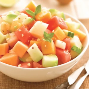 Melon Mingle fruit salad by Zestful Blends, showcasing fresh and colorful melon slices artfully arranged in a serving bowl.