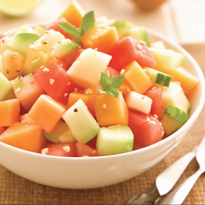 Delight in the sweetness of Melon Mingle – a fresh fruit salad crafted with the finest melons by Zestful Blends. Melon Mingle fruit salad by Zestful Blends, showcasing fresh and colorful melon slices artfully arranged in a serving bowl.